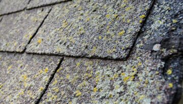 Age worn down roof shingles at the end of lifespan.