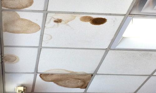 An office ceiling leaking from improper roof.