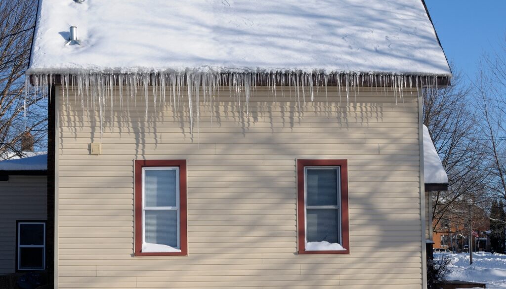 Residential home with a ton of snow and ice on the roof.