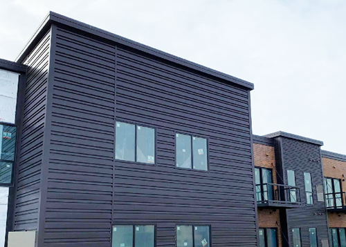 New siding installed on the Main square apartment's by Ledegar Roofing