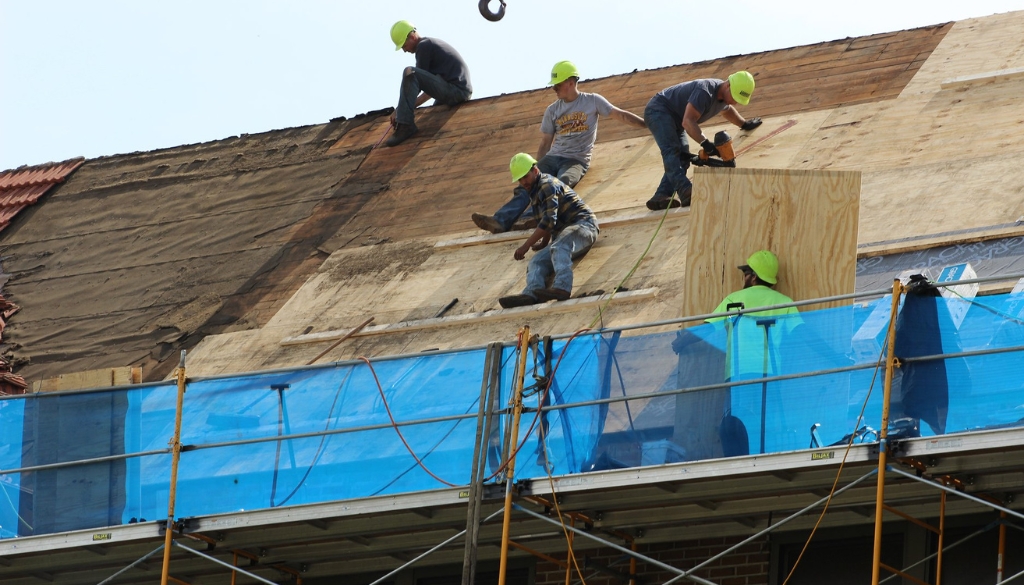 Ledegar Roofing Installers work to add a new roof to a house in La Crosse, WI.
