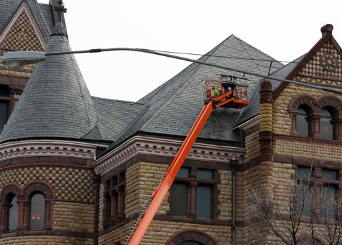 Ledegar Roofing roofer doing preventive roof maintenance on an historical building in La Crosse, Wisconsin.