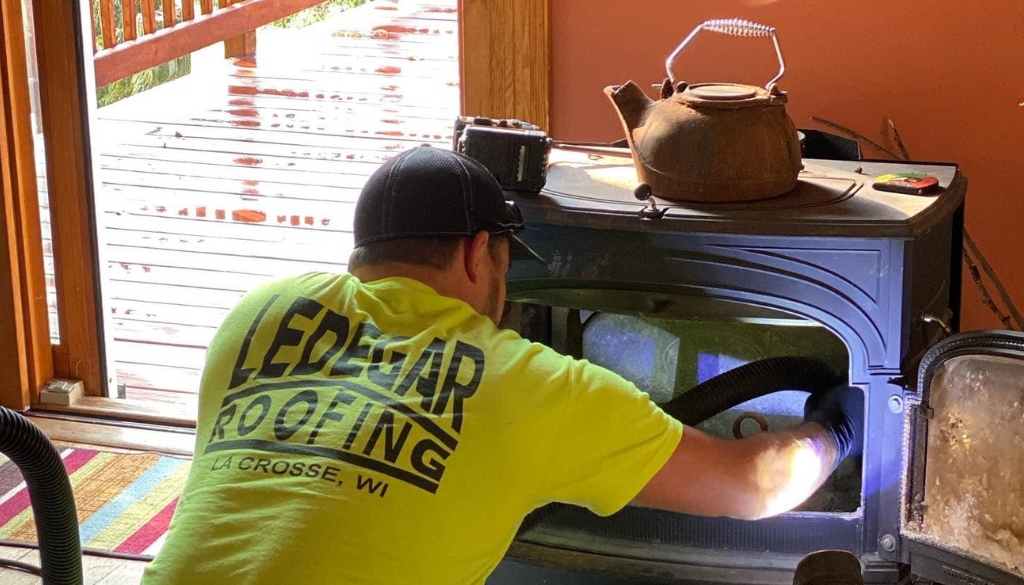 Ledegar Roofing employee inspects a chimney in a home during a routine maintenance inspection.