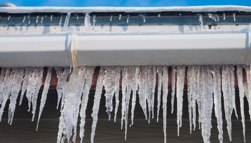 Icicles hanging around the gutter of a home.