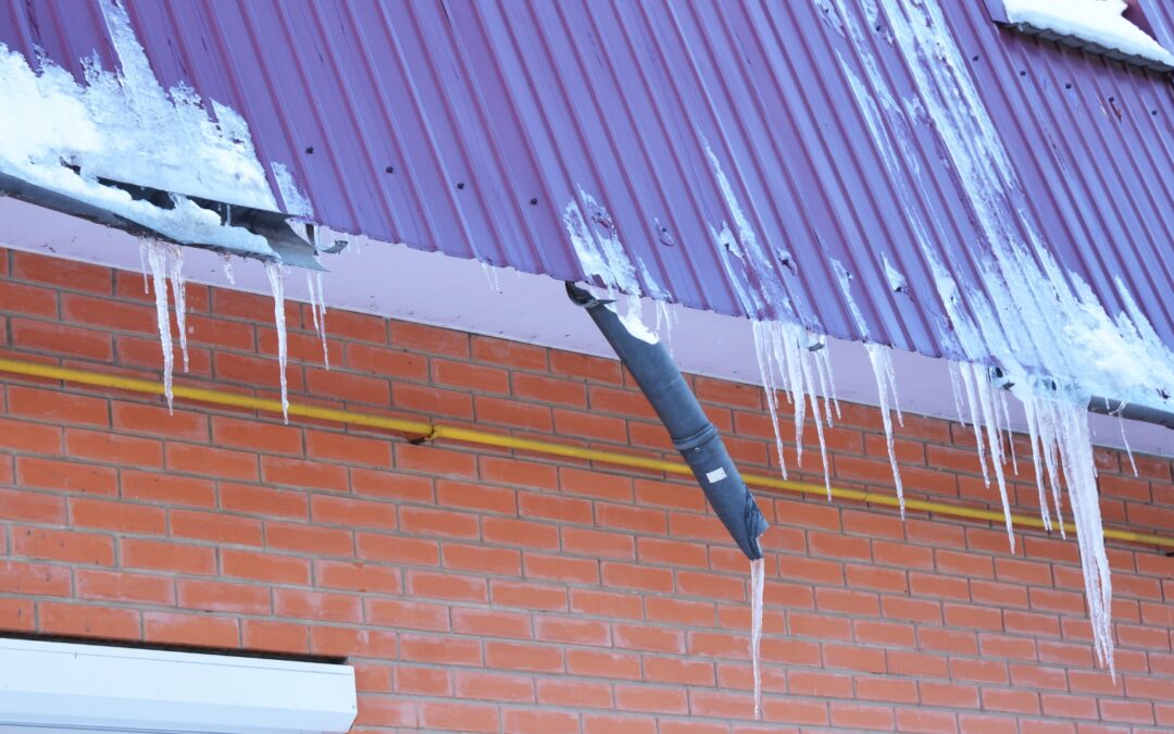 Broken gutters covered in ice and snow from the harsh winters of La Crosse, Wisconsin.
