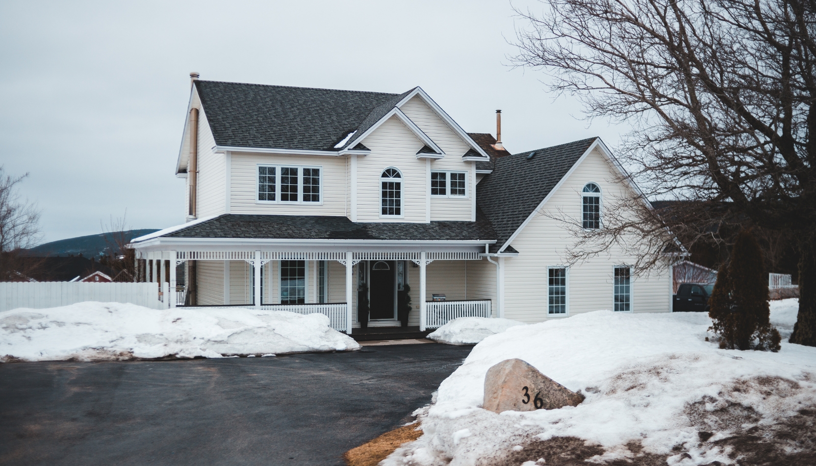 A light yellow residential home in the country of Wisconsin in late winter / early spring.