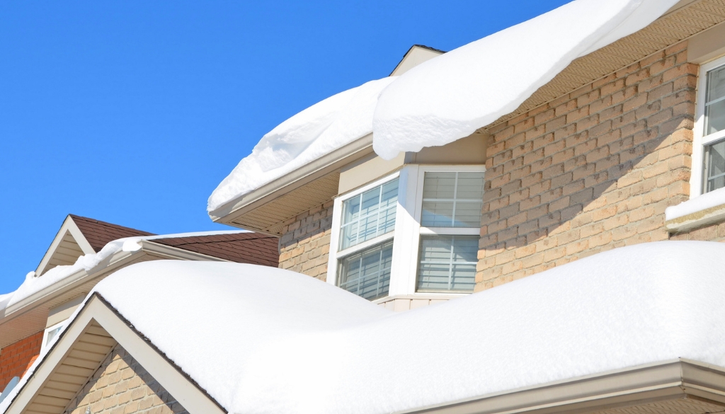 Residential home with snow on the roof.