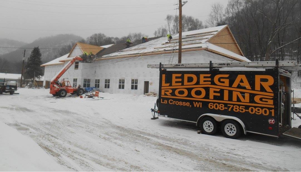 Ledegar Roofing company completing a winter roofing repair for Hiawath Health Clinic in Winona, MN.