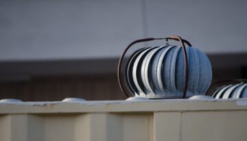 Roof turbines on a building in winter.