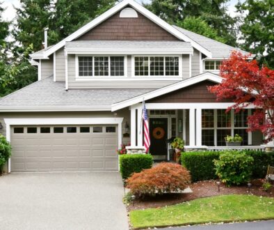 Home displaying curb appeal with landscape and a new roof.