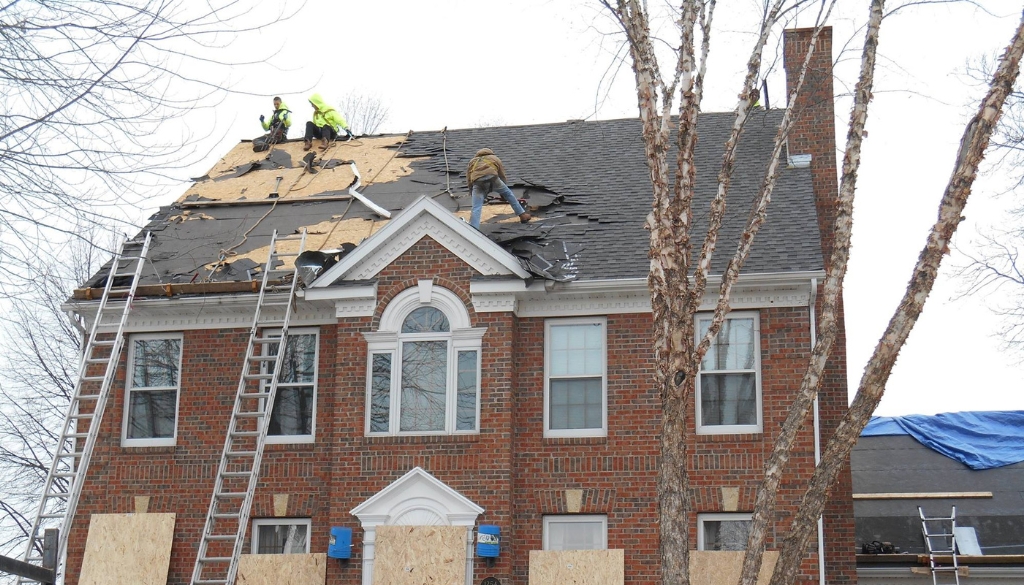 Ledegar Roofing employees replacing a roof on a home in the spring in La Crosse, Wisconsin.