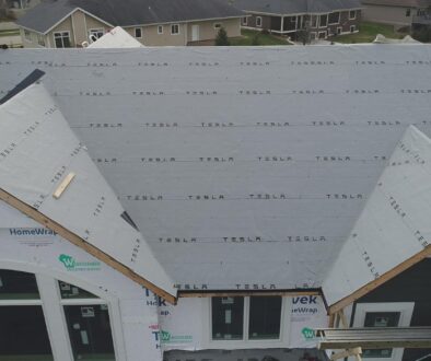 House in West Salem, WI with a Tesla Solar Panel Roof by Ledegar Roofing.