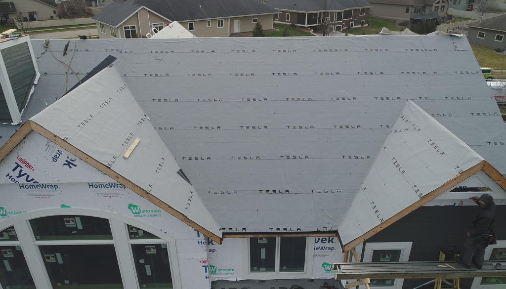 House in West Salem, WI with a Tesla Solar Panel Roof by Ledegar Roofing.