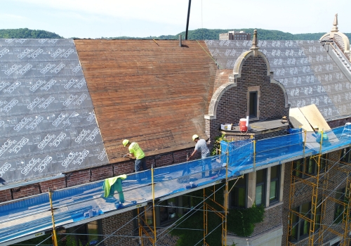 Ledegar Roofing crew members replacing the roof of a church building in La Crosse, Wisconsin. 