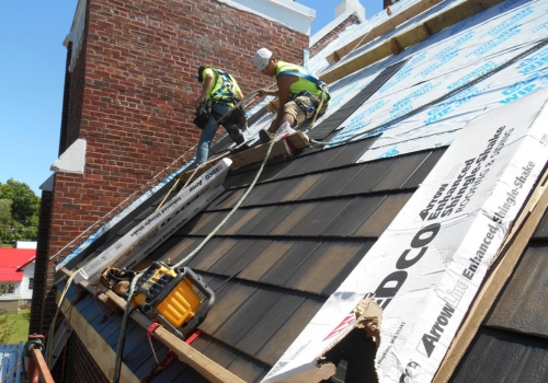 Ledegar Roofing crew members replacing a residential roof. 