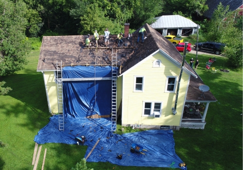 Ledegar Roofing crew members replacing the roof on a Victorian residential home.
