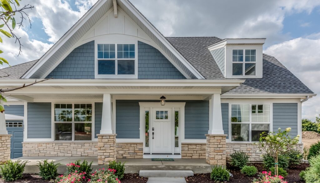 A house with beautiful, new, blue siding.