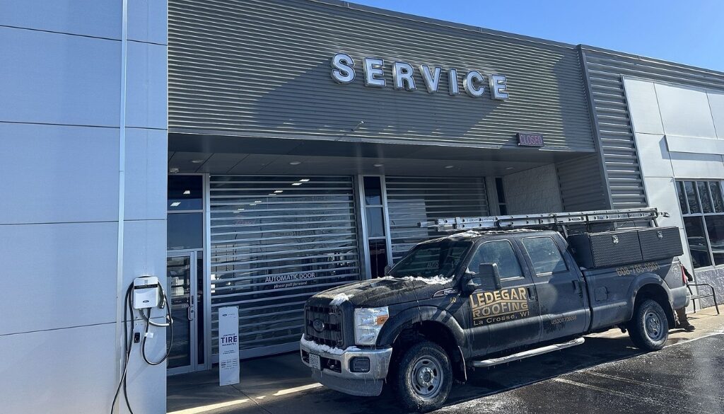 Remodeled Dahl Auto Service siding with Ledegar Roofing truck in front.