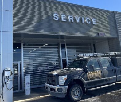 Remodeled Dahl Auto Service siding with Ledegar Roofing truck in front.