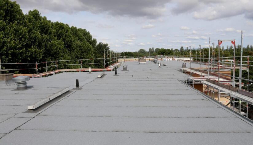 A flat commercial roof with scaffolding around it.