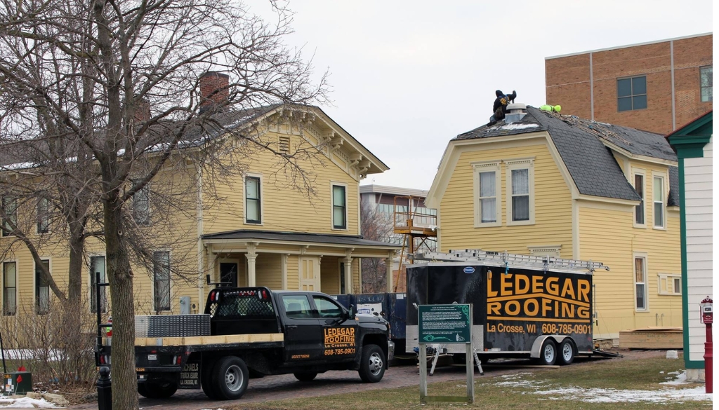 Ledegar Roofing experts replacing Hixon House's historic carriage house's roof in La Crosse, Wisconsin.