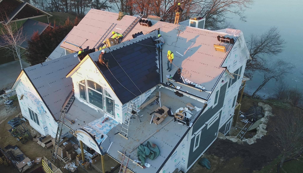 Ledegar Roofing experts installing a Tesla solar roof on a residential home in West Salem, Wisconsin.