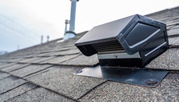 Close-up of a roof ventilation system installed on asphalt shingles.