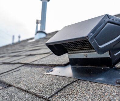 Close-up of a roof ventilation system installed on asphalt shingles.