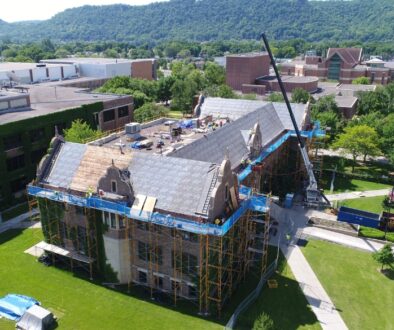 An aerial view of Ledegar Roofing working on UW-La Crosse campus building during business hours.