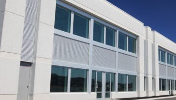 A grey commercial building with horizontal siding.