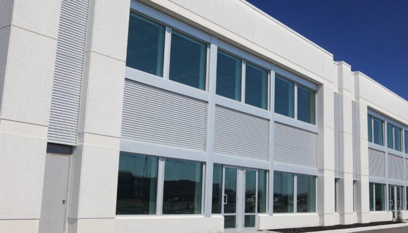 A grey commercial building with horizontal siding.