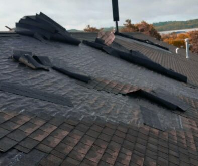 Missing shingles and severe roof damage after a storm in La Crosse, Wisconsin.