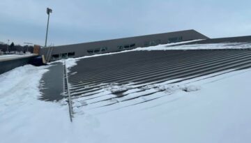 The UW La Crosse fieldhouse's snow covered flat roof.