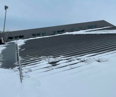 The UW La Crosse fieldhouse's snow covered flat roof.