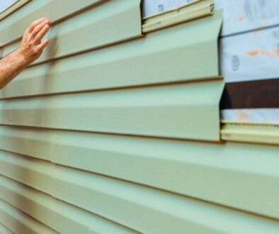 ledegar-roofing-siding-when-to-replace-worker-repair-green-panels