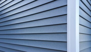 Close-up of the corner of a house with blue siding.