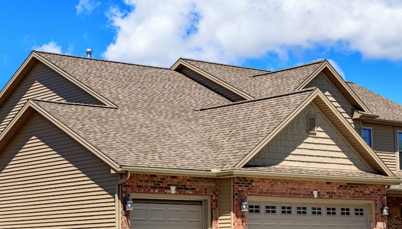 House with a brown roof. The roof has many peaks and valleys.